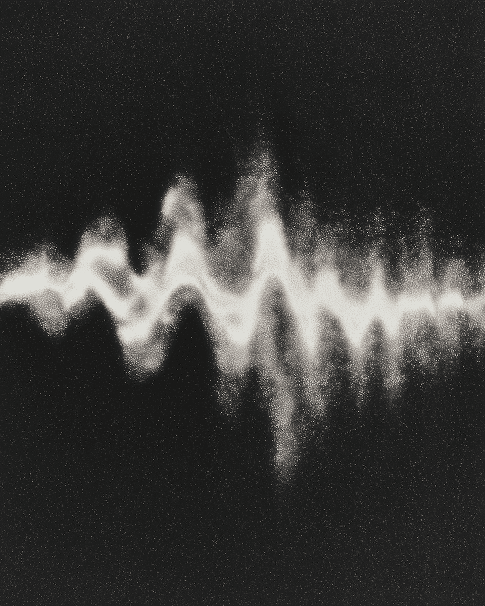 Abstract wave-like pattern of white particles on a black background, resembling sound or energy waves with a glowing, dynamic effect.